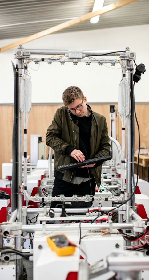 man-in-brown-jacket-using-a-machine.jpg man in brown jacket using a machine